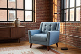 Comacchio armchair in a brick-walled loft with steel windows, a walnut sideboard and a black floor lamp