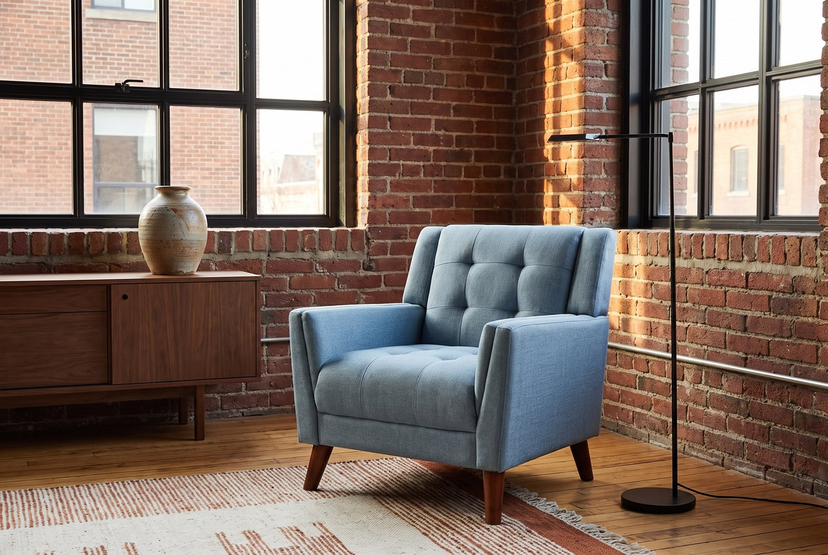 Comacchio armchair in a brick-walled loft with steel windows, a walnut sideboard and a black floor lamp