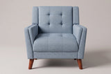 Comacchio armchair in blue, straight front view: tufted back between two upright posts, flared track arms
