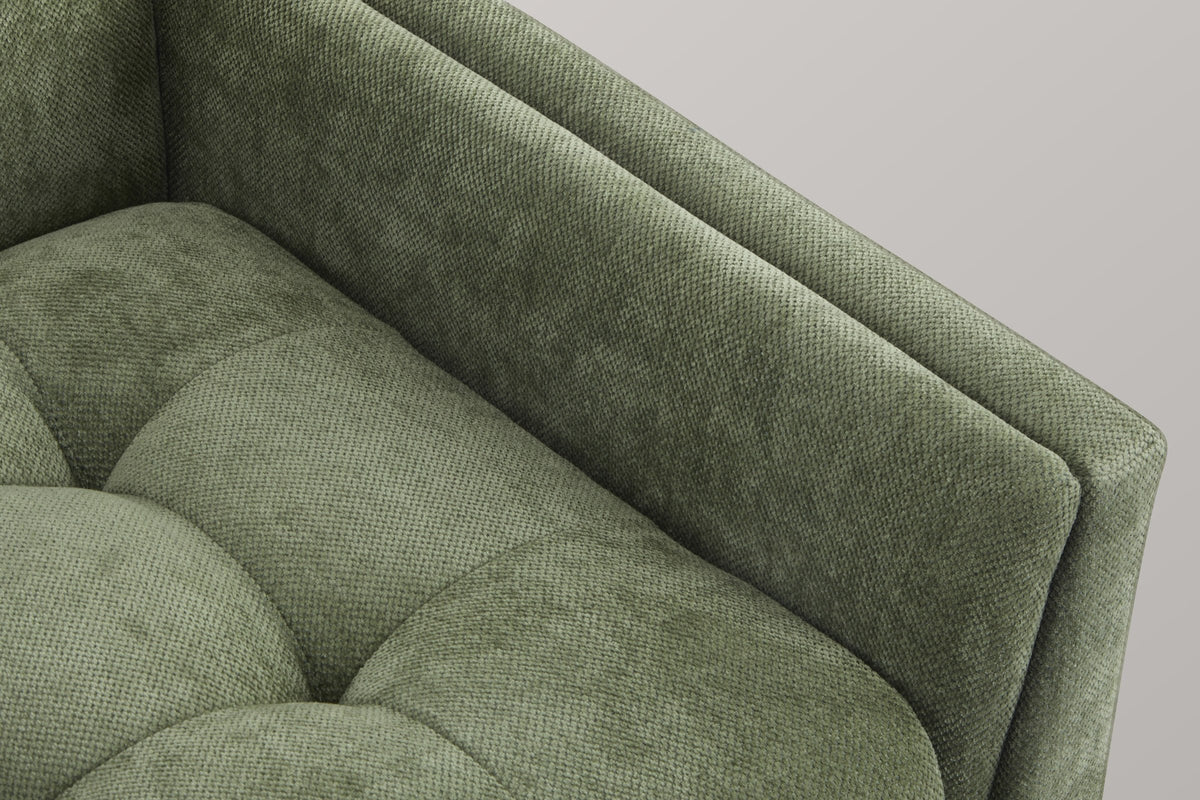 Close-up of the green chenille arm and tufted seat, with the sewn tufts and the soft pebble-weave texture