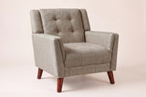 Comacchio tufted mid-century armchair in light brown, three-quarter view on a warm off-white backdrop