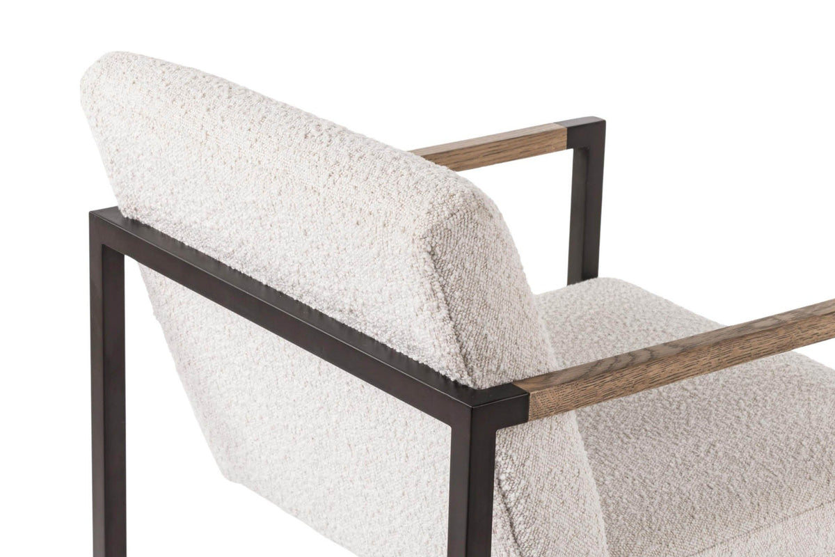 Close-up of the Coreglia back: the covered back cushion, the square iron frame and an ash arm