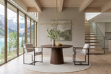 Two Coreglia dining armchairs in White at a round walnut pedestal table in a Lake Louise mountain house