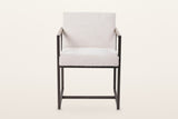 Coreglia dining armchair in White, front view on a warm white studio backdrop: the thick seat flush with the front posts