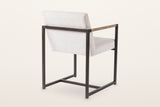 Coreglia dining armchair in White from the back at three-quarter on a warm white studio backdrop: the back rail and the cross