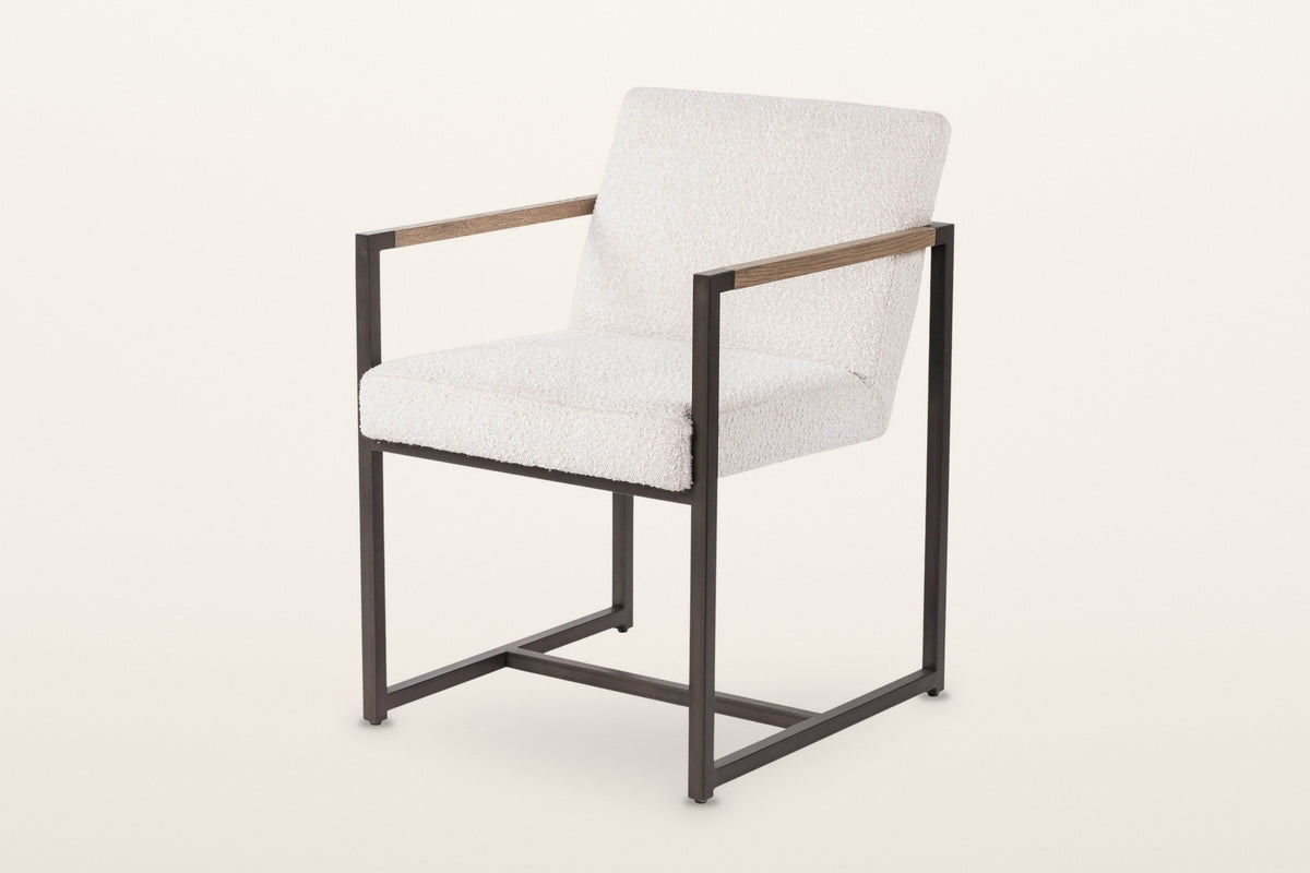 Coreglia dining armchair in White, three-quarter view on a warm white studio backdrop: a looped fabric seat and back in a sli