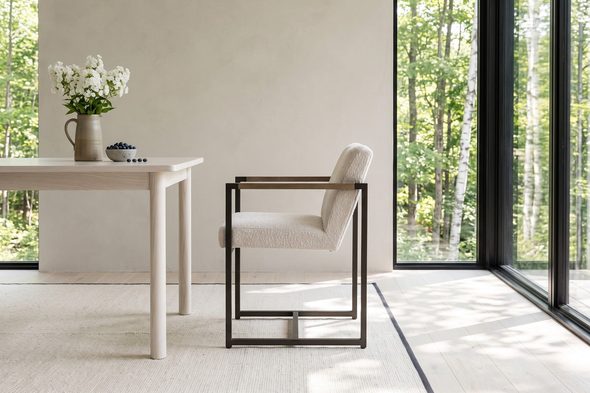 A Coreglia dining armchair in White in side profile beside a white ash table in a Val-David house