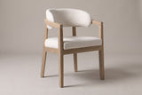 Corinaldo curved-back dining chair in Beige linen-look fabric, three-quarter view on a warm grey studio backdrop
