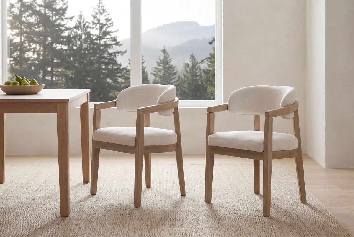 A pair of Corinaldo dining chairs pulled out from a white-oak table in a bright Vancouver dining room with cedar trees