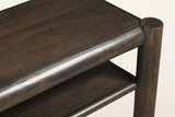 Close-up of a Corniglia top corner in mocha: the round leg top, the rounded rail and the dark espresso finish over mango grain