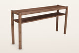 Corniglia mango wood console table in walnut, three-quarter view on a warm white studio backdrop