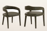 Two Corniglia armchairs in moss faux leather, front and back three-quarter views: the curved back band, the open gap above the seat and the upholstered legs