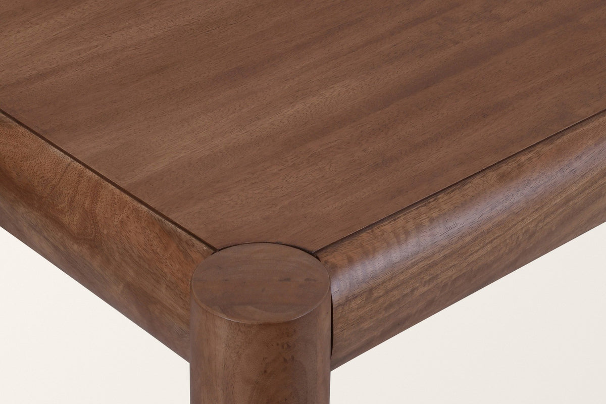 Close-up of a Corniglia corner in walnut: the round leg top flush with the surface, the rounded rails and the mango veneer panel