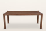 The Corniglia table alone, long side: four round legs and a round rail frame around the walnut mango top