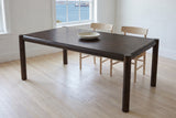 Corniglia dining table in mocha in a white Halifax dining room with a harbour view