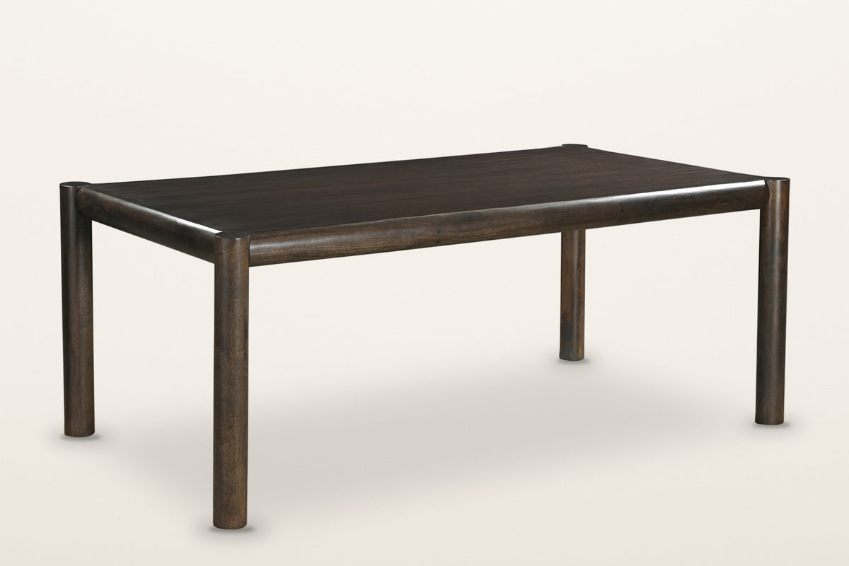 Corniglia mango wood dining table in mocha, three-quarter view on a warm white studio backdrop