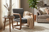 Corwin Charcoal accent chair with a knit throw in a sunny living room