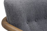 Close-up of the Corwin Charcoal tufted back and curved wood arm