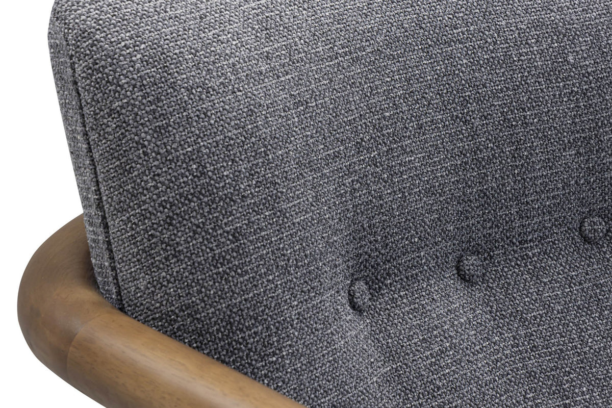 Close-up of the Corwin Charcoal tufted back and curved wood arm