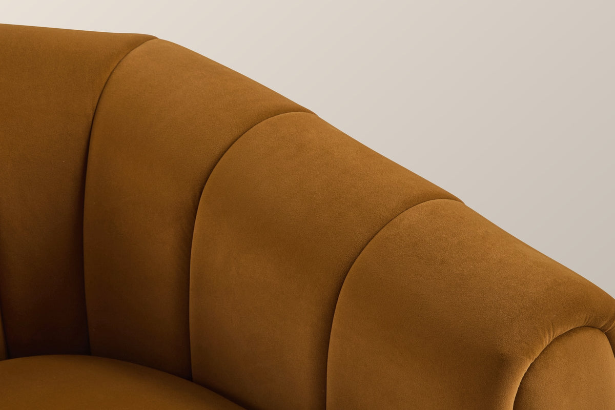 Close-up of a channelled velvet arm and its rolled front edge in caramel