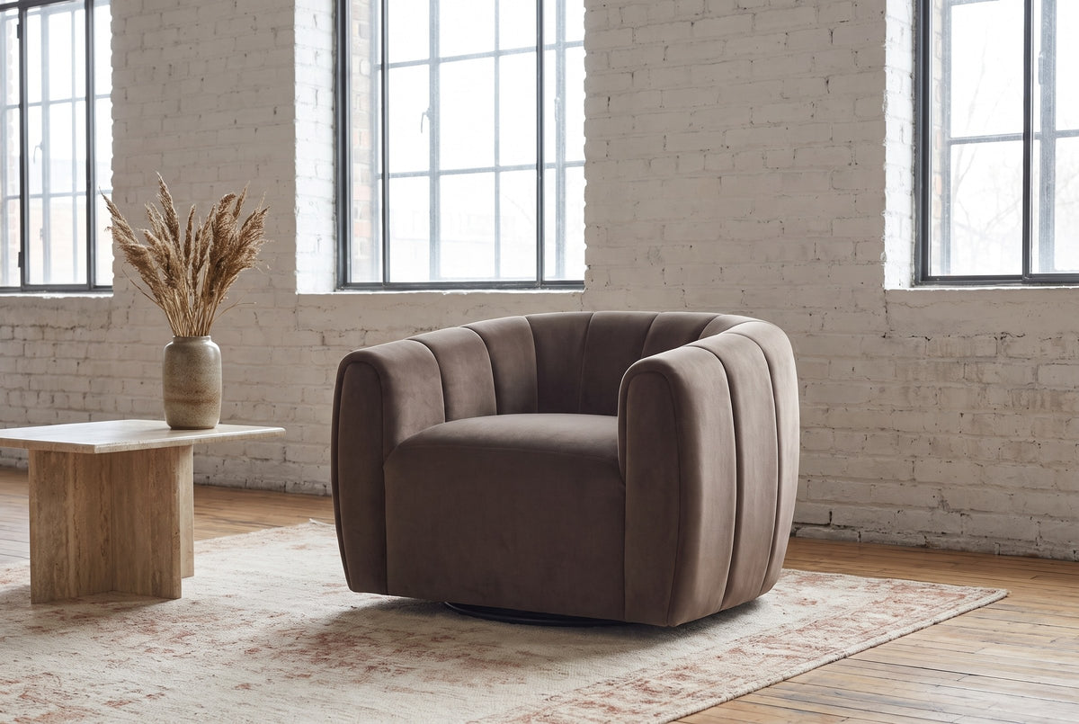 Cuneo swivel chair in a Montreal loft with whitewashed brick, steel windows and a travertine side table