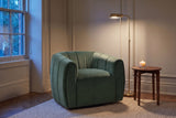 Cuneo swivel chair in olive green velvet in a panelled Toronto townhouse corner at dusk