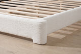 Close-up of a sculpted boucle foot at the corner of the Cupello bed