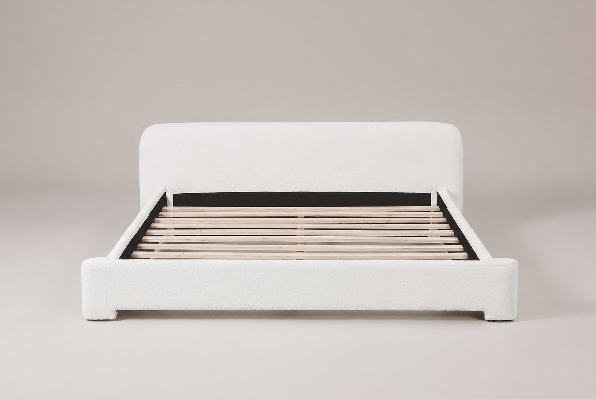 Cupello boucle platform bed in white, straight front view with the slats showing
