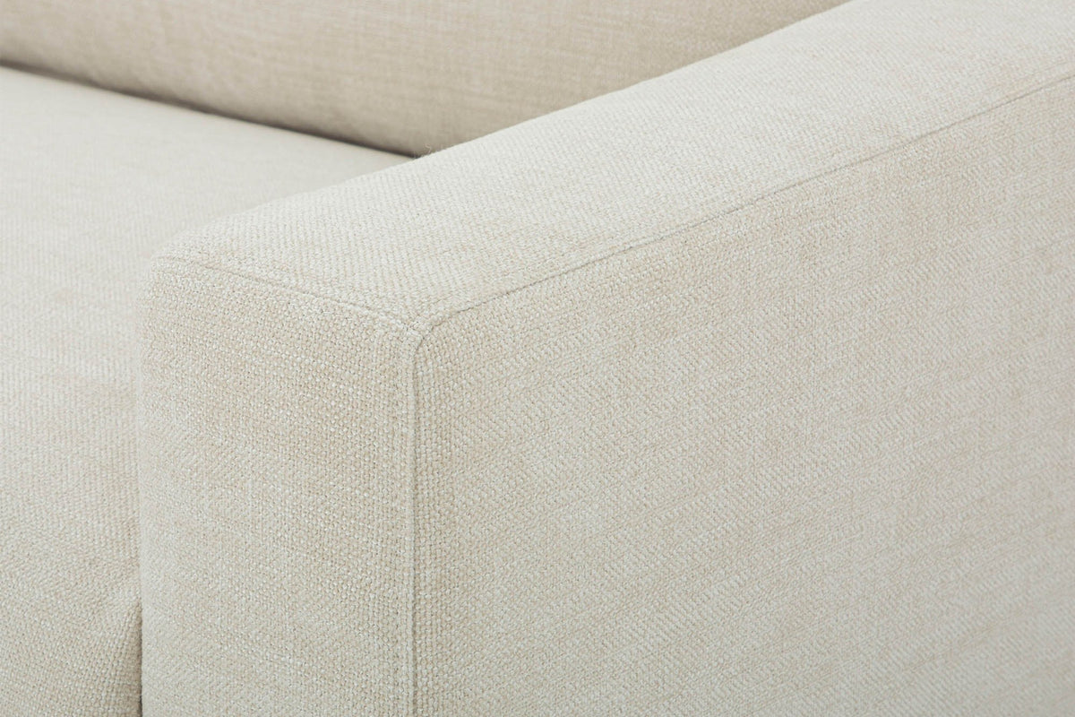 Close-up of the Cupramontana arm in Beige: the softly rounded front corner of the arm and the woven polyester