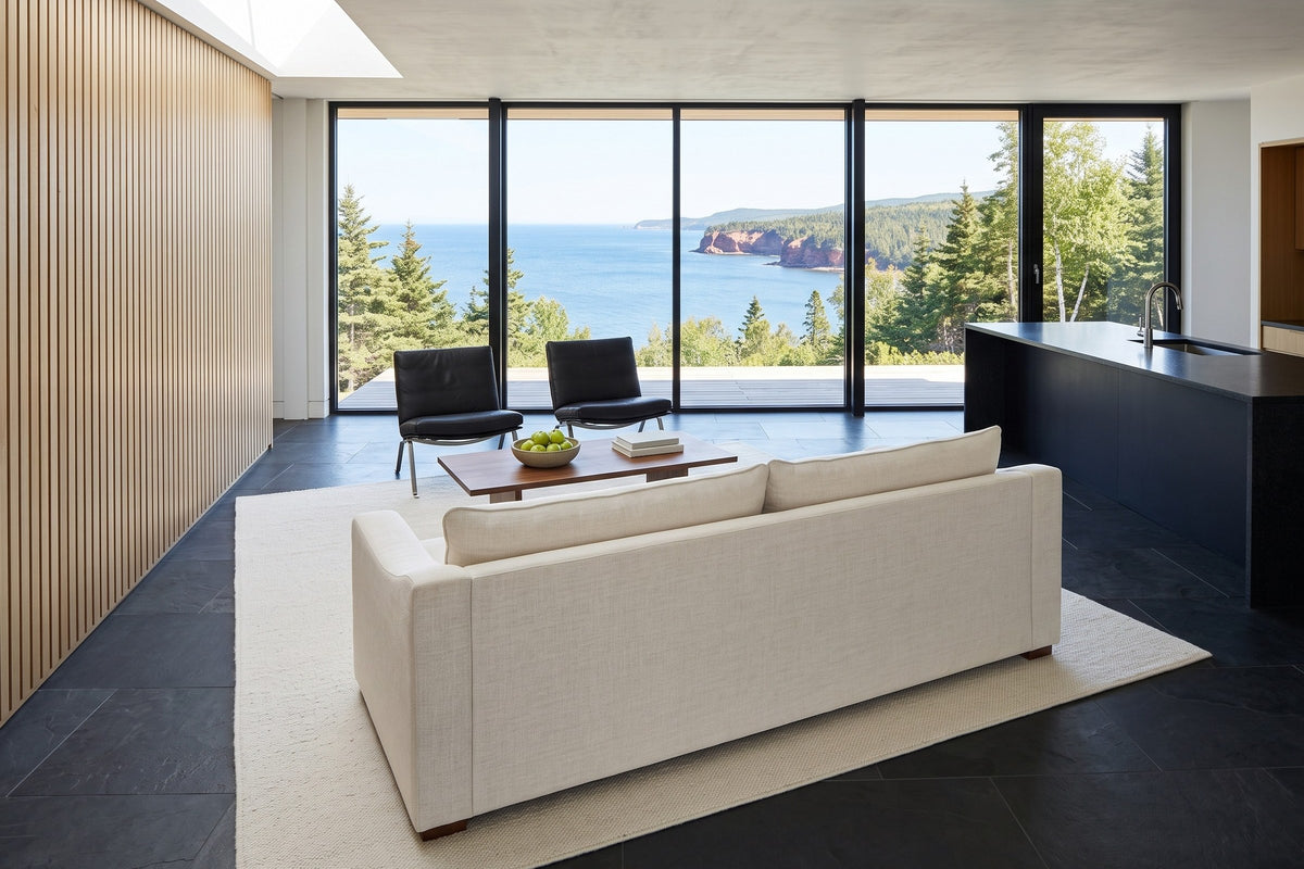Cupramontana sofa in Beige seen from behind and above in a Gaspe house, a white-oak slat wall