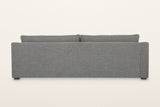 Back of the Cupramontana sofa in Grey on a warm white studio backdrop: a plain upholstered back panel with the back cushions