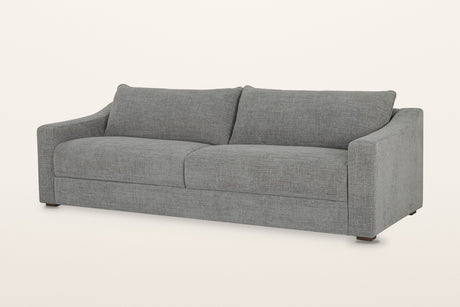 Cupramontana sofa in Grey, three-quarter view on a warm white studio backdrop