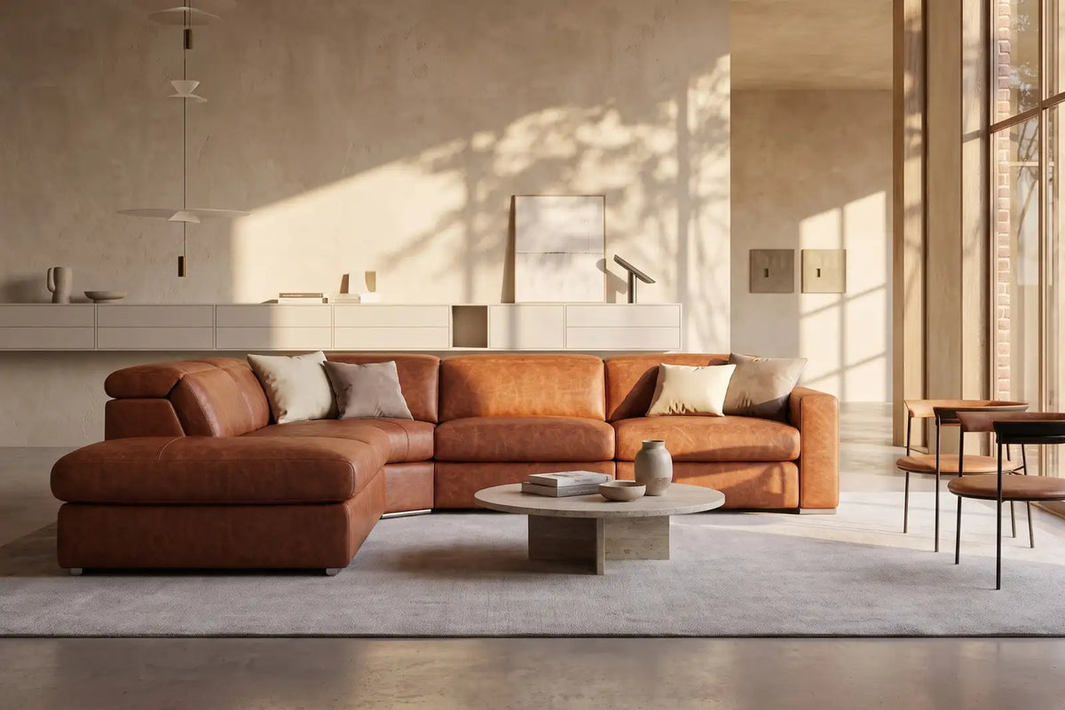 Distressed leather sectional in a bright warm contemporary living room