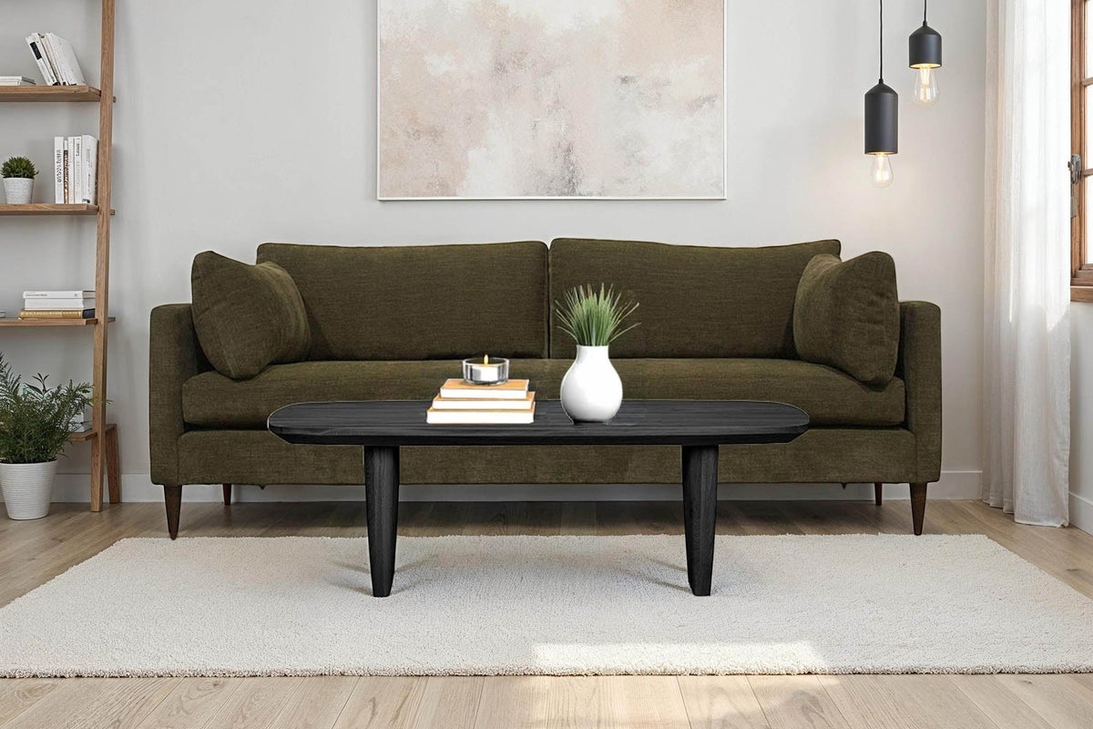 Darby Pine green woven fabric sofa in a bright living room with a black oval coffee table