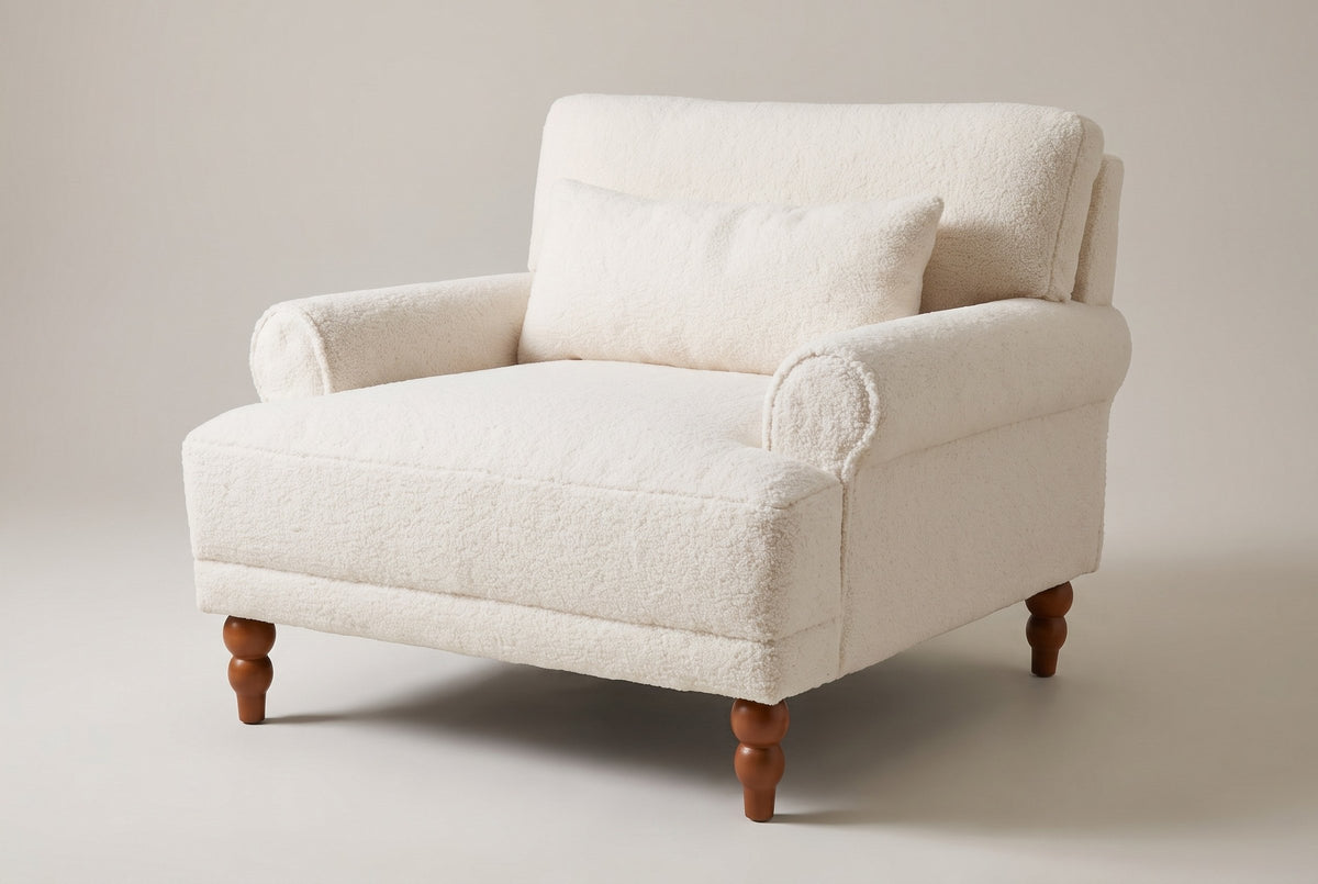 Dolceacqua oversized accent chair in ivory sherpa, three-quarter view on a warm grey studio backdrop