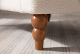 Close-up of a turned wood leg in a chestnut stain: two stacked beads above a tapered foot