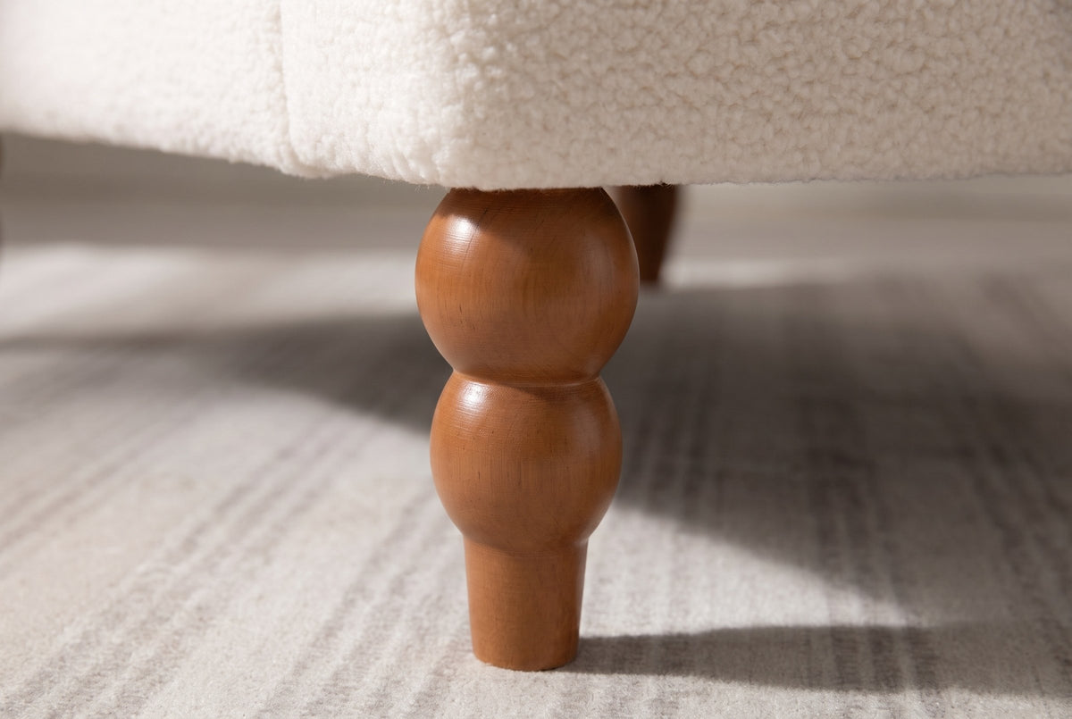 Close-up of a turned wood leg in a chestnut stain: two stacked beads above a tapered foot