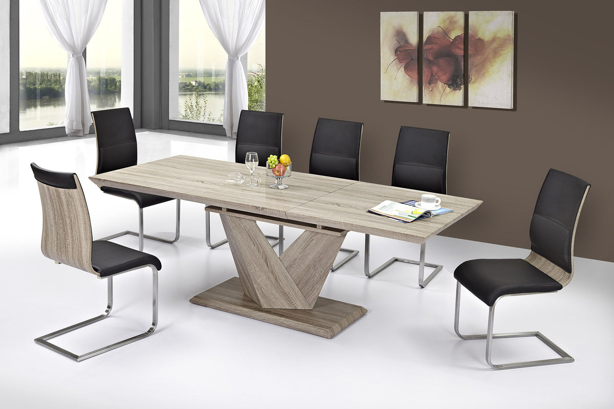 Ellis washed oak extension dining table with black and chrome chairs in a modern dining room
