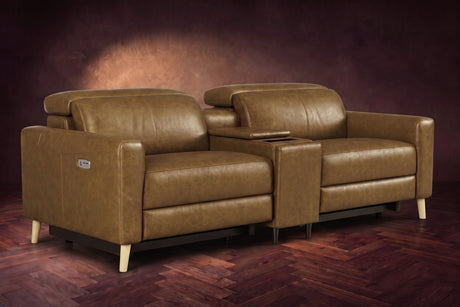 The Elodie sofa with console in Weathered Saddle distressed full leather on a dark herringbone floor, headrests down and footrests closed.