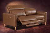 The Elodie loveseat on a dark walnut herringbone floor, the left seat reclined with its footrest out and its headrest raised. Shown in Weathered Saddle, Loveseat.