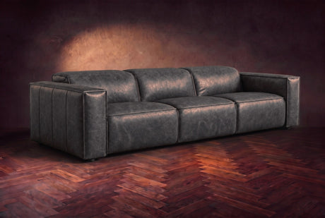 The Emery 3 seat in Aged Slate distressed full leather on a dark herringbone floor, headrests down and footrests closed. Shown in Aged Slate, 3 seat.