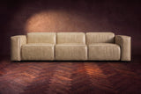 The Emery 3 seat seen from the front in Washed Sand distressed full leather on a dark herringbone floor, headrests down. Shown in Washed Sand, 3 seat.