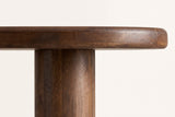 Close-up of the Erbusco base: a round solid mango post leg meeting the underside of the rounded top