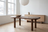 Erbusco dining table in dark walnut in a white Montreal loft on a winter morning