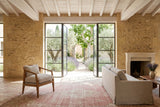 Esanatoglia accent chair in Sand Boucle in a Saint-Remy-de-Provence house, with honey limestone walls