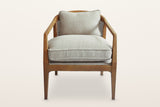 Esanatoglia accent chair, straight front view on a warm white studio backdrop: the ash band turning down at angular elbows