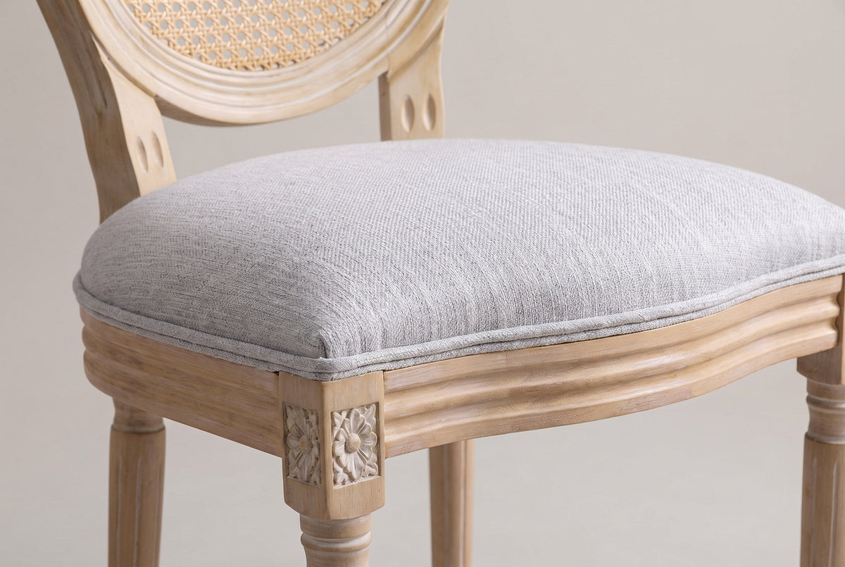 Close-up of the Este light grey woven seat, its fine welt, the grooved seat rail and a carved rosette corner
