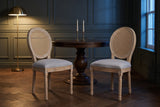 Two Este dining chairs in a green-grey panelled Toronto dining room at dusk