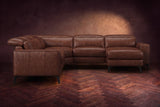 The Esther sectional seen from the front in Burnished Chestnut distressed full leather on a dark herringbone floor, the chaise facing the camera and the footrest closed. Shown in Burnished Chestnut, Right chaise.