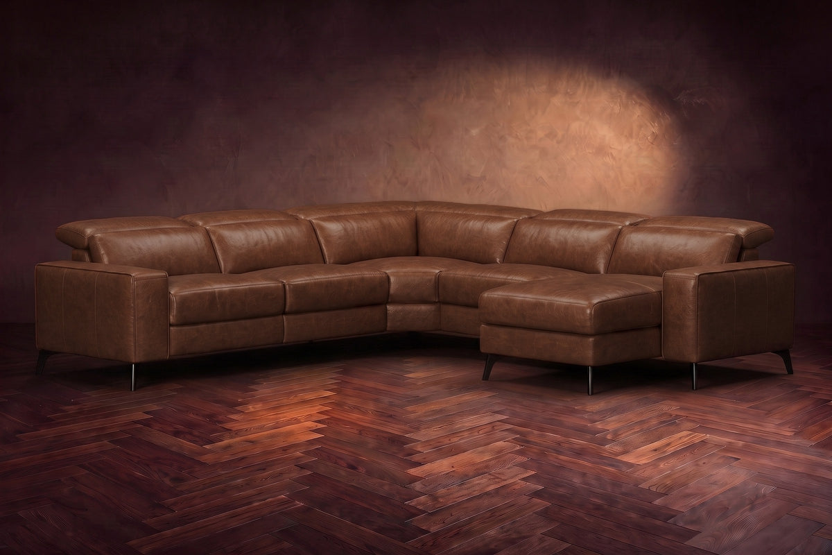 The Esther sectional in Burnished Chestnut distressed full leather on a dark herringbone floor, headrests down and footrest closed. Shown in Burnished Chestnut, Right chaise.